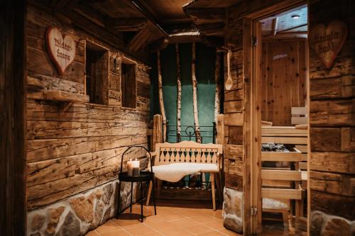 a room in a log cabin with a bench and a candle at Hotel Happy Filzmoos in Filzmoos