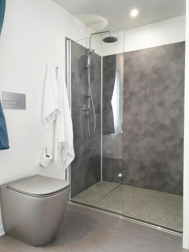 a bathroom with a shower with a toilet and a glass shower stall at Camping Union Lido in Cavallino-Treporti