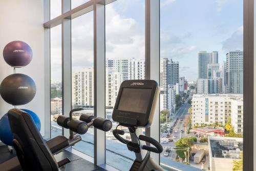 a gym with a view of a city from a window at Novotel Miami Brickell in Miami