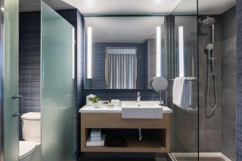 a bathroom with a sink, toilet and bathtub at Novotel Miami Brickell in Miami
