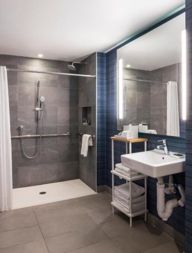 a bathroom with a sink and a shower at Novotel Miami Brickell in Miami