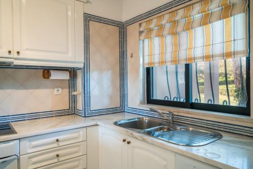 a kitchen with a sink and a window at Alto Golf Sea Oceanview in Alvor