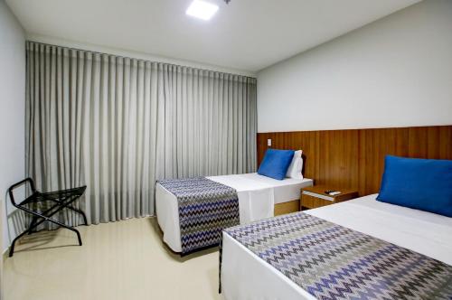 Una cama o camas en una habitación de Advanced Hotel & Flats Cuiabá