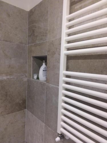 a bathroom with a shower with a white shelf at Rina Rooms in Vernazza