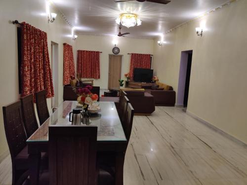 a living room with a dining table and a couch at Quinte Hills Residency in Panchgani