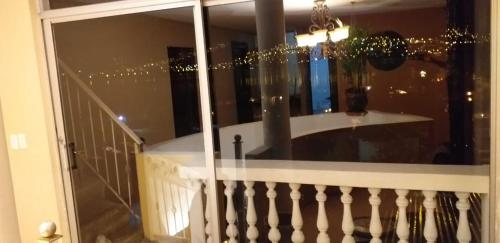 a room with a balcony with a table and a window at Bellavista Casa de Huéspedes in San Pablo