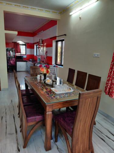 a dining room with a wooden table and chairs at Quinte Hills Residency in Panchgani