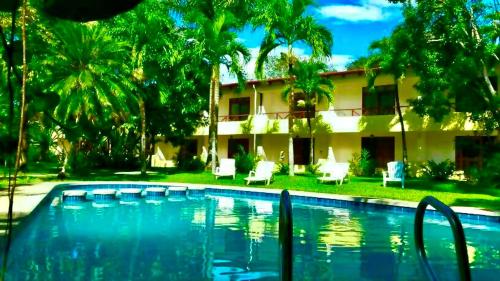 a swimming pool in front of a house at Samara Beach Hotel in Sámara