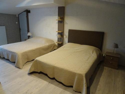 a room with two beds in a room at La Lauriére in Treize-Vents