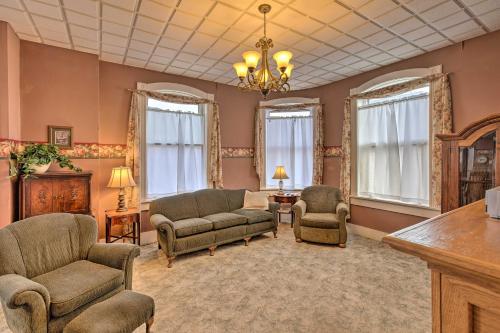 a living room with a couch and chairs and windows at Pet-Friendly Apt Walk to Missouri River! in Yankton