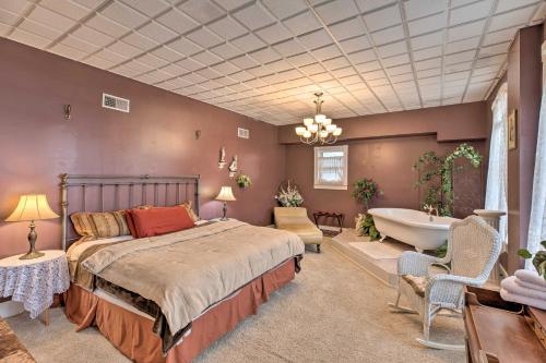 a bedroom with a bed and a tub and a sink at Pet-Friendly Apt 2 Blocks to Riverside Park! in Yankton