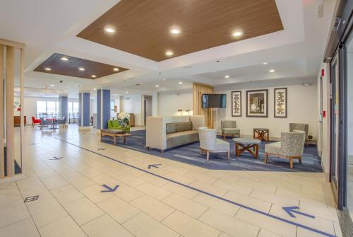 a lobby with blue arrows on the floor at Holiday Inn Express Hotel & Suites Gulf Shores by IHG in Gulf Shores