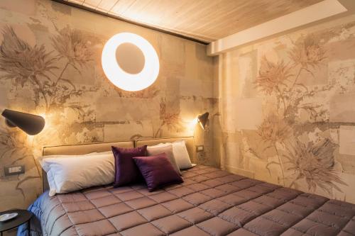 a bedroom with a bed with a light on the wall at Residenza Benizzi rooms in the heart of Florence in Florence