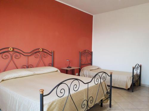 a bedroom with a bed and a dresser at Tahiti House Stagnone in Marsala
