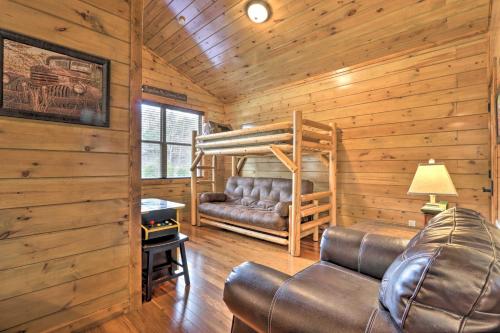 a log cabin living room with a couch and a bunk bed at Rustic Pigeon Forge Cabin with Hot Tub Near Town! in Pigeon Forge