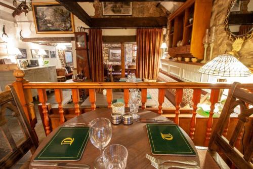 a wooden table with wine glasses on top of it at The Tankerville Arms in Eglingham