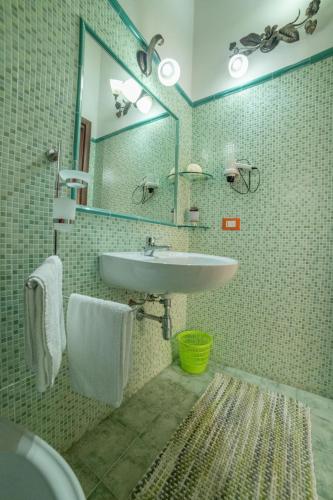 a bathroom with a sink and a mirror at Residenza La Grazia Tropea - Free Parking - in Tropea