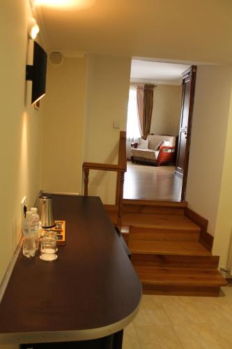 a living room with a table and a living room with a couch at Spadok in Kamianets-Podilskyi