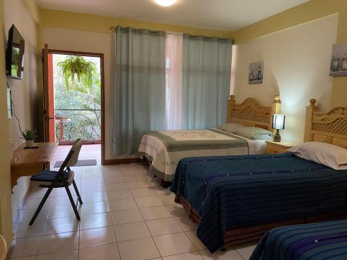A bed or beds in a room at Hotel-Villas JABEL TINAMIT