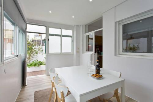 a white dining room with a white table and chairs at O´Porto Covelo Flat in Porto