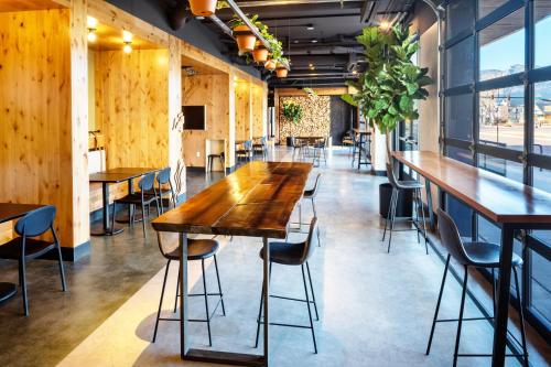 a long wooden table in a room with chairs at Kinship Landing in Colorado Springs