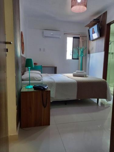 Ένα ή περισσότερα κρεβάτια σε δωμάτιο στο Hotel Gogó da Ema