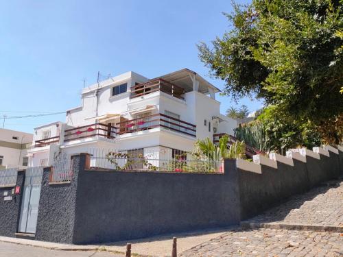 a white building with a fence in front of it at Casa Doramas VV in Las Palmas de Gran Canaria