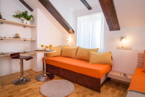 a small room with a bed and a table at Split Inn Apartments in Split