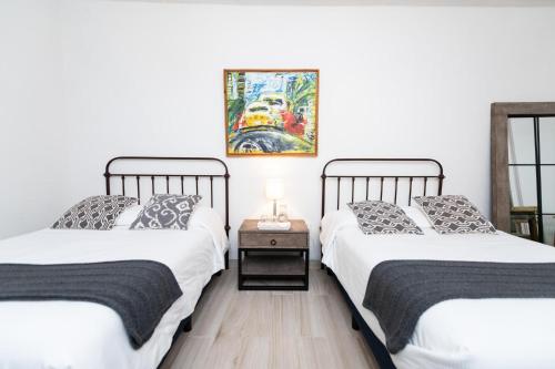 two beds sitting next to each other in a room at Casa De La O in San Miguel de Allende