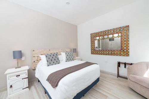 a bedroom with a bed and a mirror on the wall at Casa De La O in San Miguel de Allende
