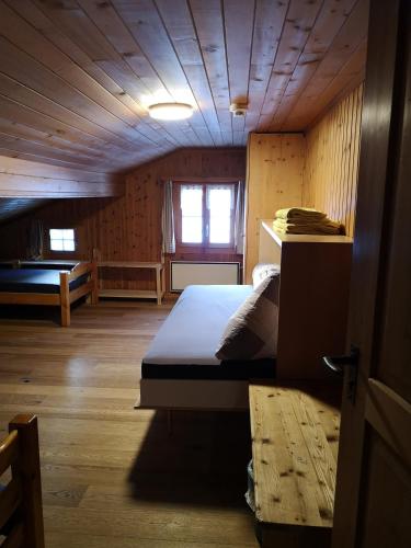 a bedroom with a bed in a wooden cabin at B&B Gassa 95 in Vals