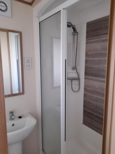 a bathroom with a shower and a sink at The Beaches - New Beach in Dymchurch