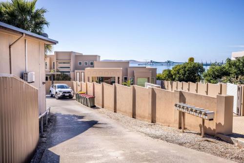 a car parked on a street next to a fence at Sea Breeze with City Ease in Port Lincoln