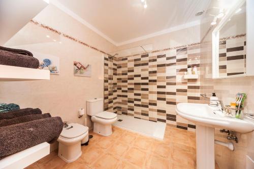 a bathroom with a toilet and a sink at Luxury Diving Apartment in Puerto del Carmen