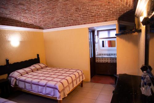 Ein Bett oder Betten in einem Zimmer der Unterkunft Hotel Hacienda de Cobos