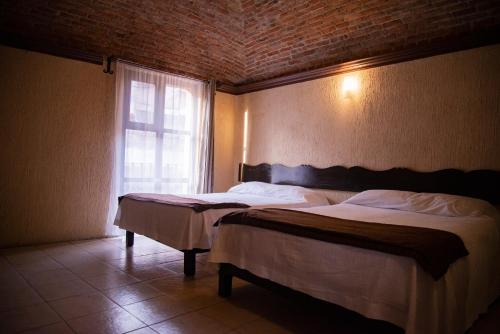 Ein Bett oder Betten in einem Zimmer der Unterkunft Hotel Hacienda de Cobos