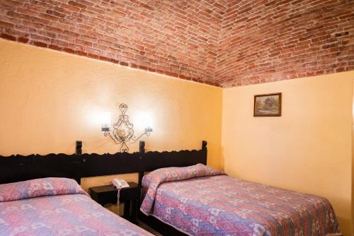 Ein Bett oder Betten in einem Zimmer der Unterkunft Hotel Hacienda de Cobos
