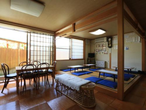 a room with tables and chairs in a room at Minshuku Miyama in Yamanouchi