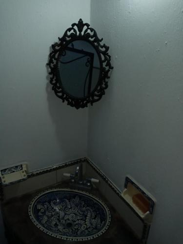 a bathroom with a sink and a mirror on the wall at Casa Tapalpa in Tapalpa