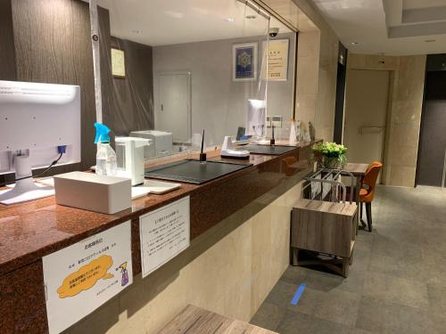 a kitchen with a counter with a counter top at Sun Royal Kawasaki in Kawasaki