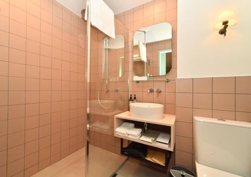a bathroom with a sink and a toilet at Sudima Auckland City in Auckland