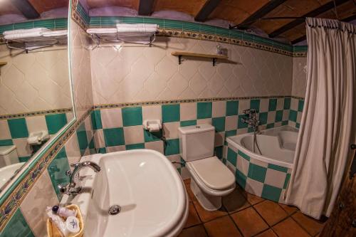 uma casa de banho com um lavatório, um WC e uma banheira em Hotel Bodega La Venta em Casas de los Pinos