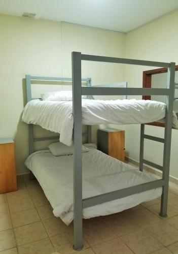 two bunk beds sitting in a room with at Sam'S VIP Hostel San Gil in San Gil