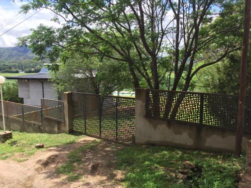 a fence in front of a yard with trees at Balcones del Lago in Villa Parque Siquiman