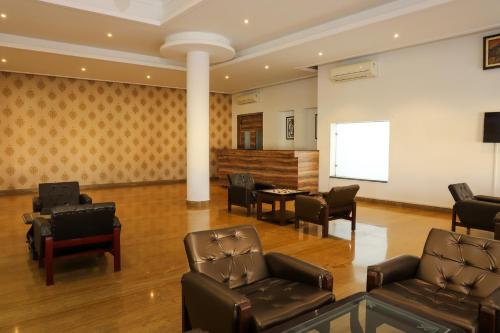 a waiting room with leather chairs and a table at Regenta Central Mewargarh, Near Biological park in Udaipur