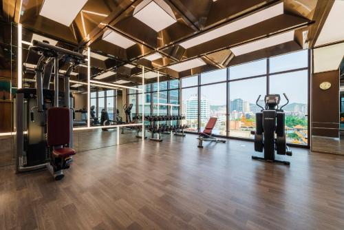 a gym with treadmills and exercise equipment in a building at Similan Hotel Zhuhai-Gongbei Port in Zhuhai