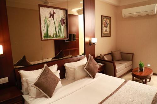 a hotel room with a bed and a couch at Hotel Golden Tower Near Heritage Street in Amritsar