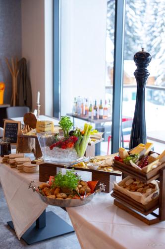 a table with a bunch of food on it at Hotel Belmont & Spa in Sinaia