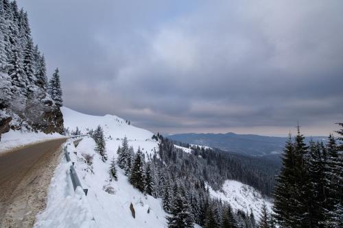 a dirt road with snow on the side of a mountain at Hotel Belmont & Spa in Sinaia