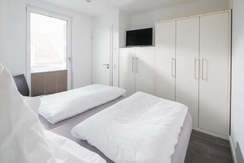 Кровать или кровати в номере Haus Insulaner Tolle 6